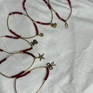 5 bracelets with different symbols